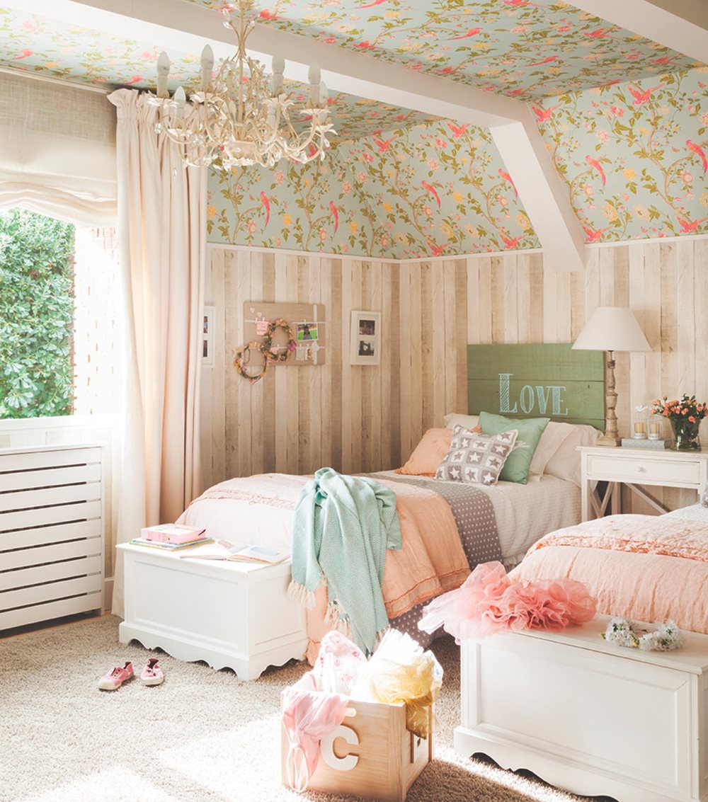 dormitorio infantil de estilo romántico con papel pintado de flores y lampara chandelier