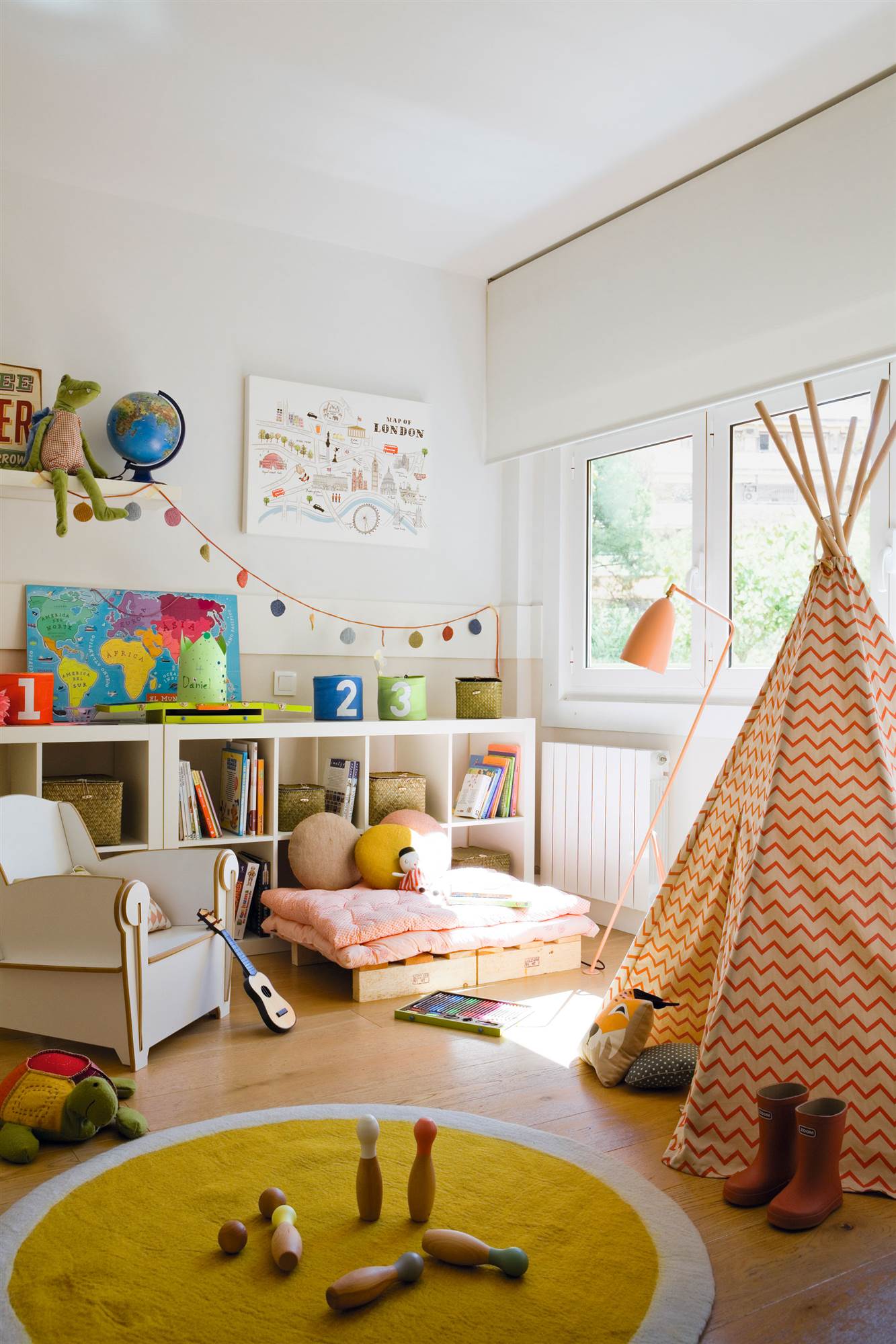 Dormitorio infantil con zona de juegos con tienda tipi y estantería baja.