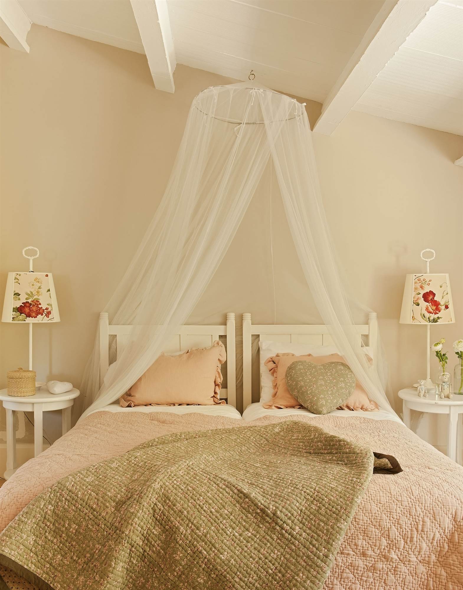 Cabecero de cama de madera pintado de color blanco y con una mosquitera.