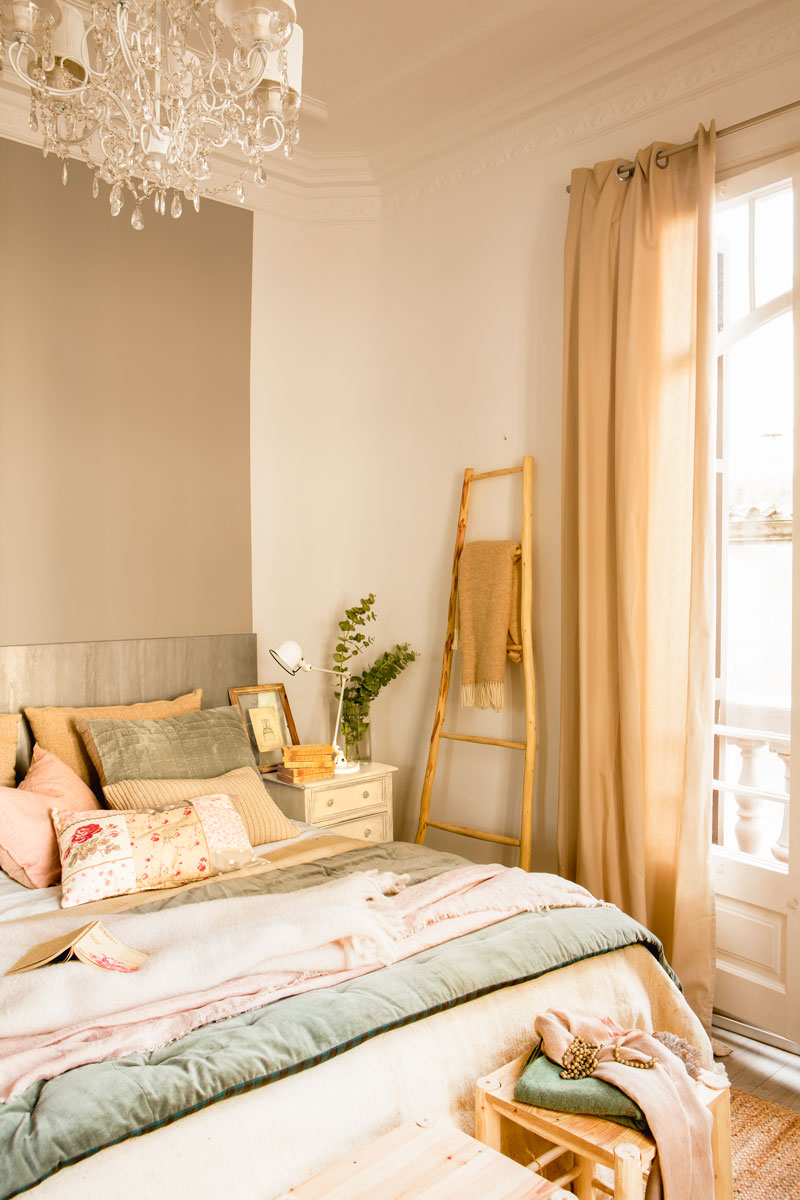 Dormitorio clásico con cama vestida de textiles