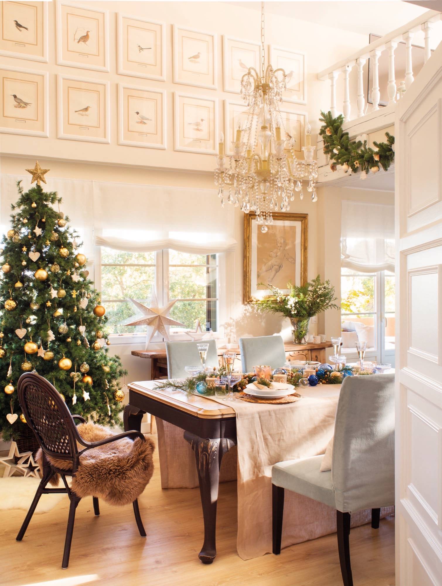 Comedor con mesa de madera junto al árbol de Navidad. 