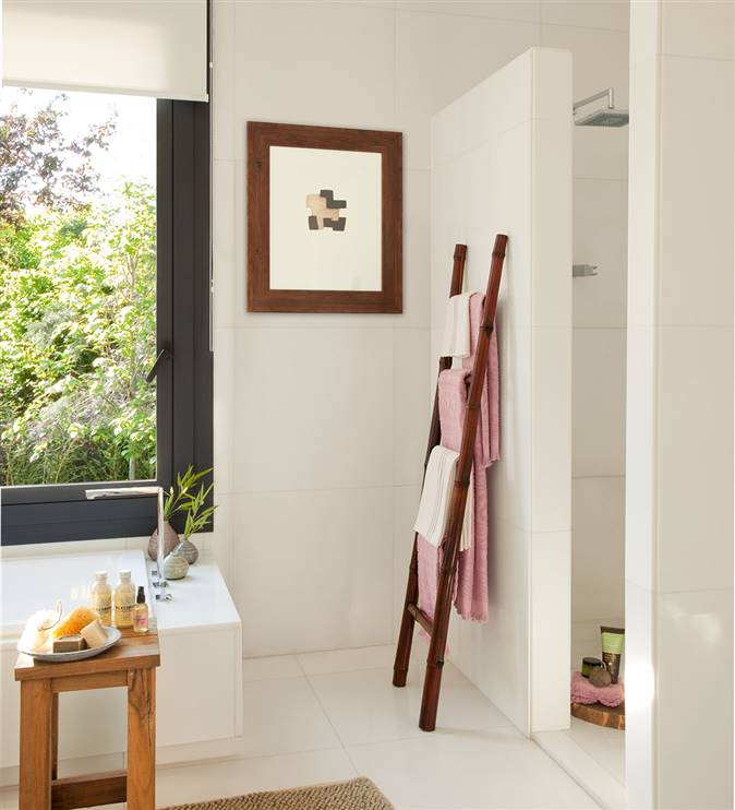 Baño con ducha y bañera y detalle toallero escalera de madera