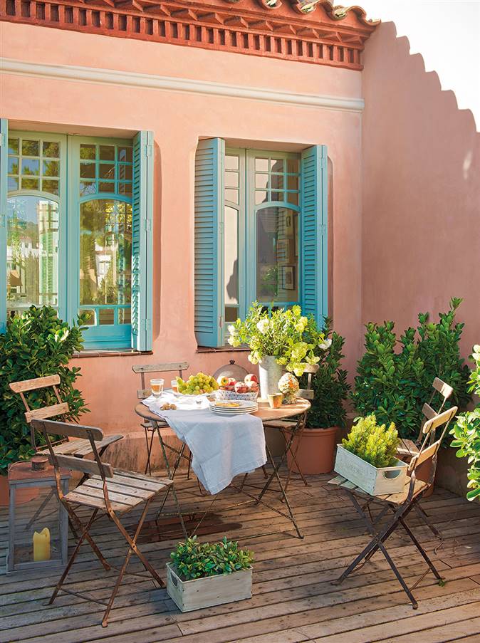 Terraza de casa con pórticos de color turquesa