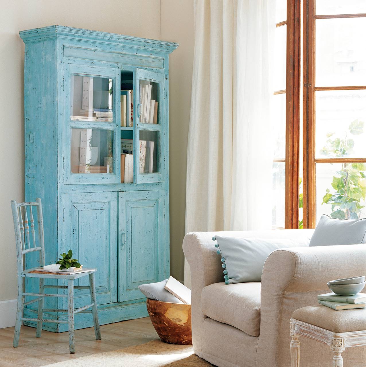 Sala de estar con armario en tono azul decapado