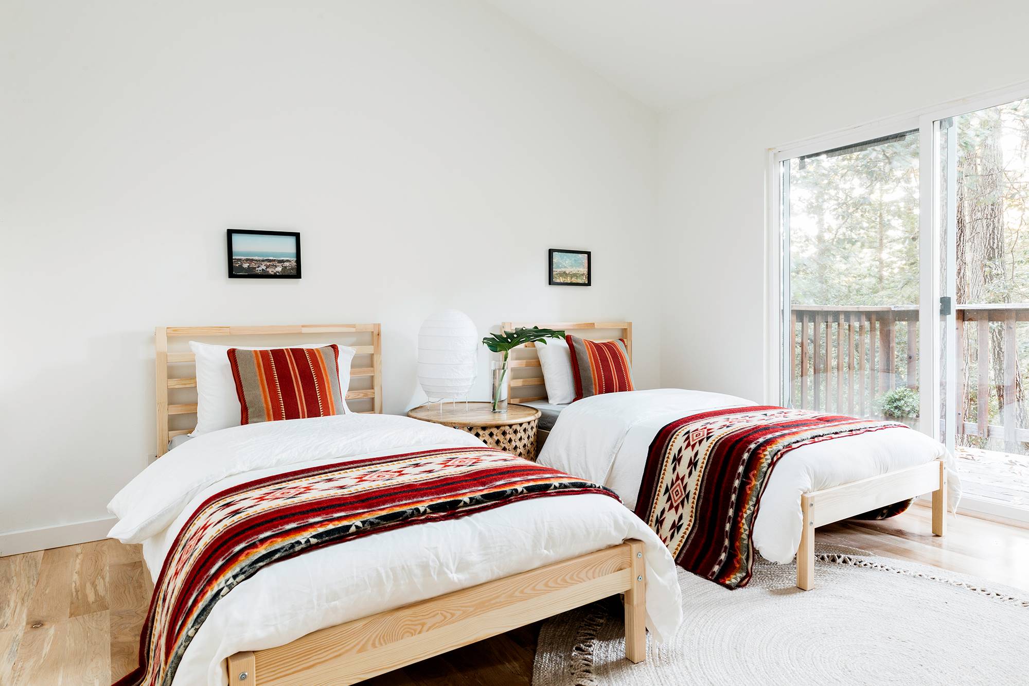 Dormitorio con dos camas de madera y ropa de cama étnica