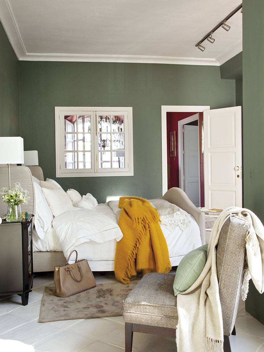 Dormitorio con paredes verdes y textiles y carpintería en blanco_00364465