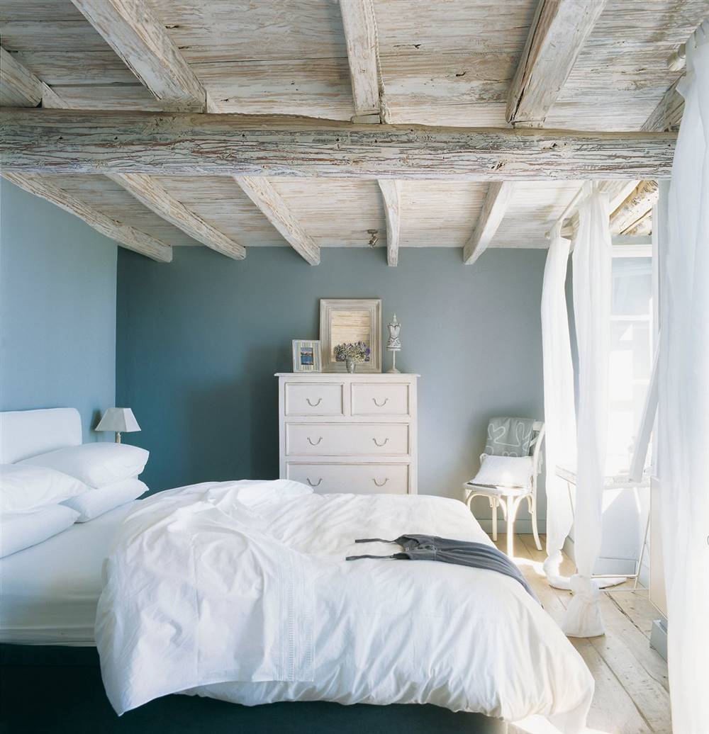Las fundas de  colchón son frescas en el dormitorio con vigas decapadas