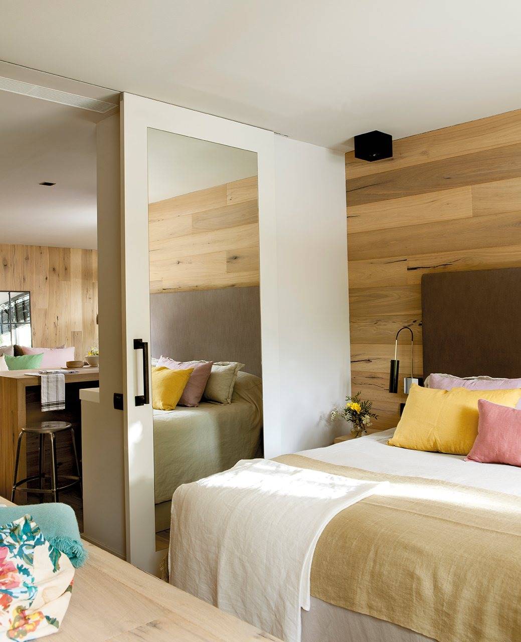 dormitorio con pared cabecero forrada de madera