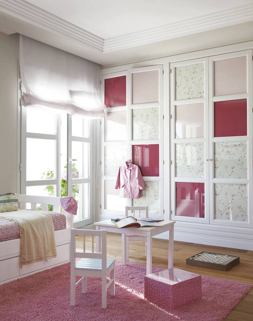 Dormitorio infantil con armario de puertas de cristal decorados con papeles lisos y estampados