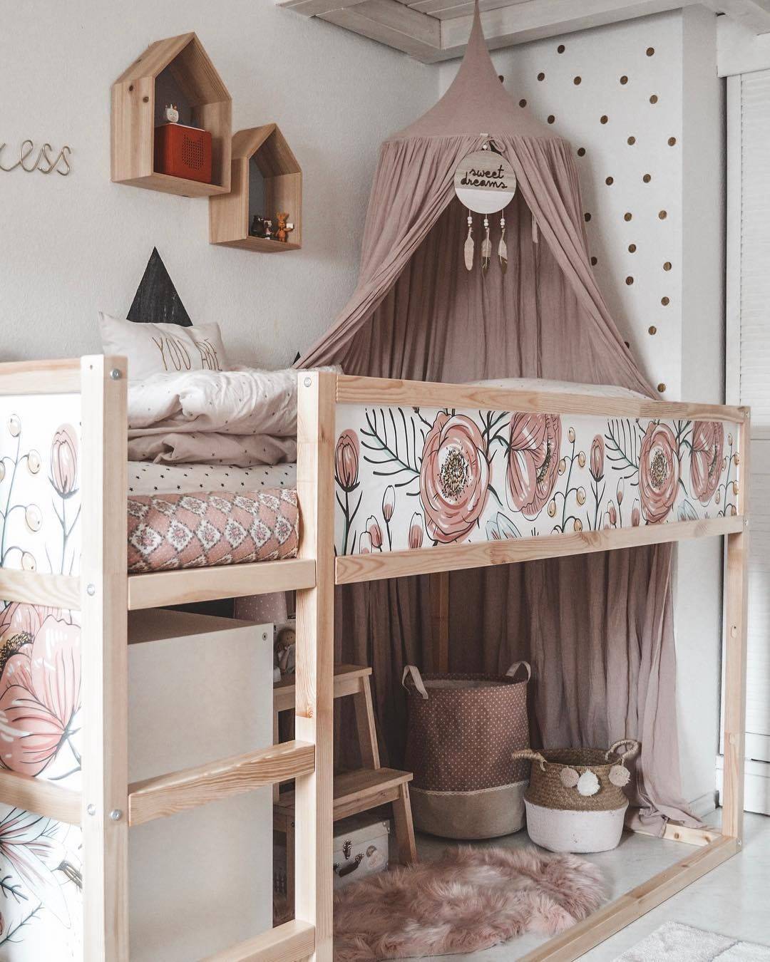 Hack de la literal infantil KURA de IKEA con estilo vintage decorada con papel pintado floral y un dosel rosa, en Instagram