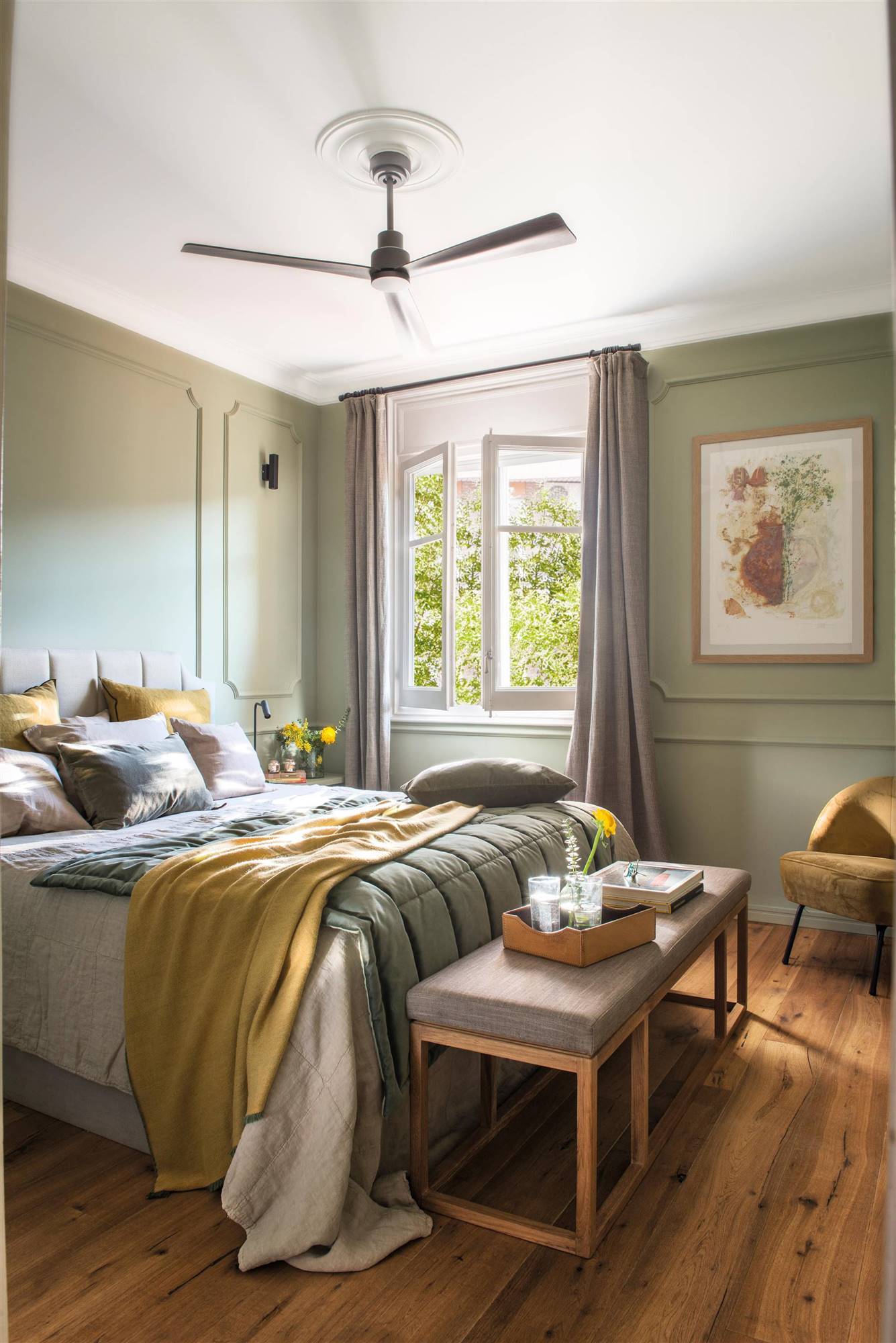 Dormitorio con paredes en verde y ropa de cama verde y mostaza. 