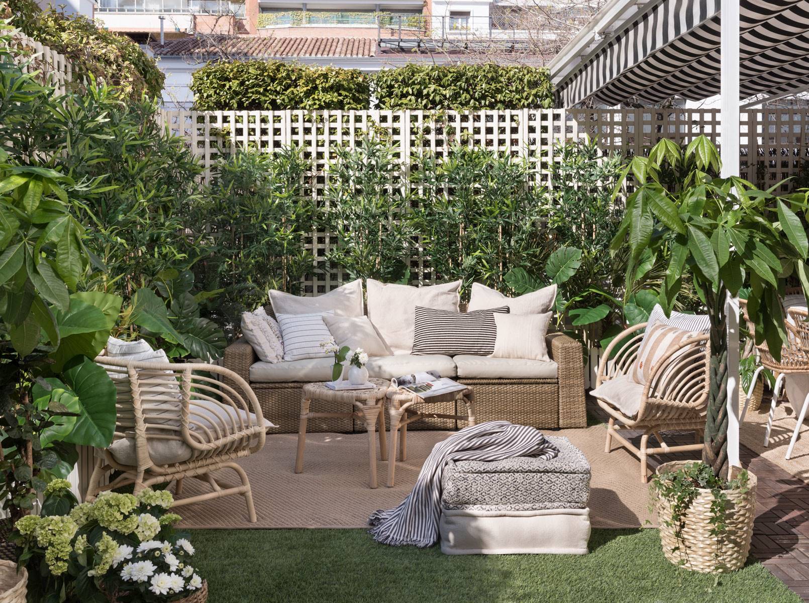 Terraza con césped artificial y muebles de jardín. 