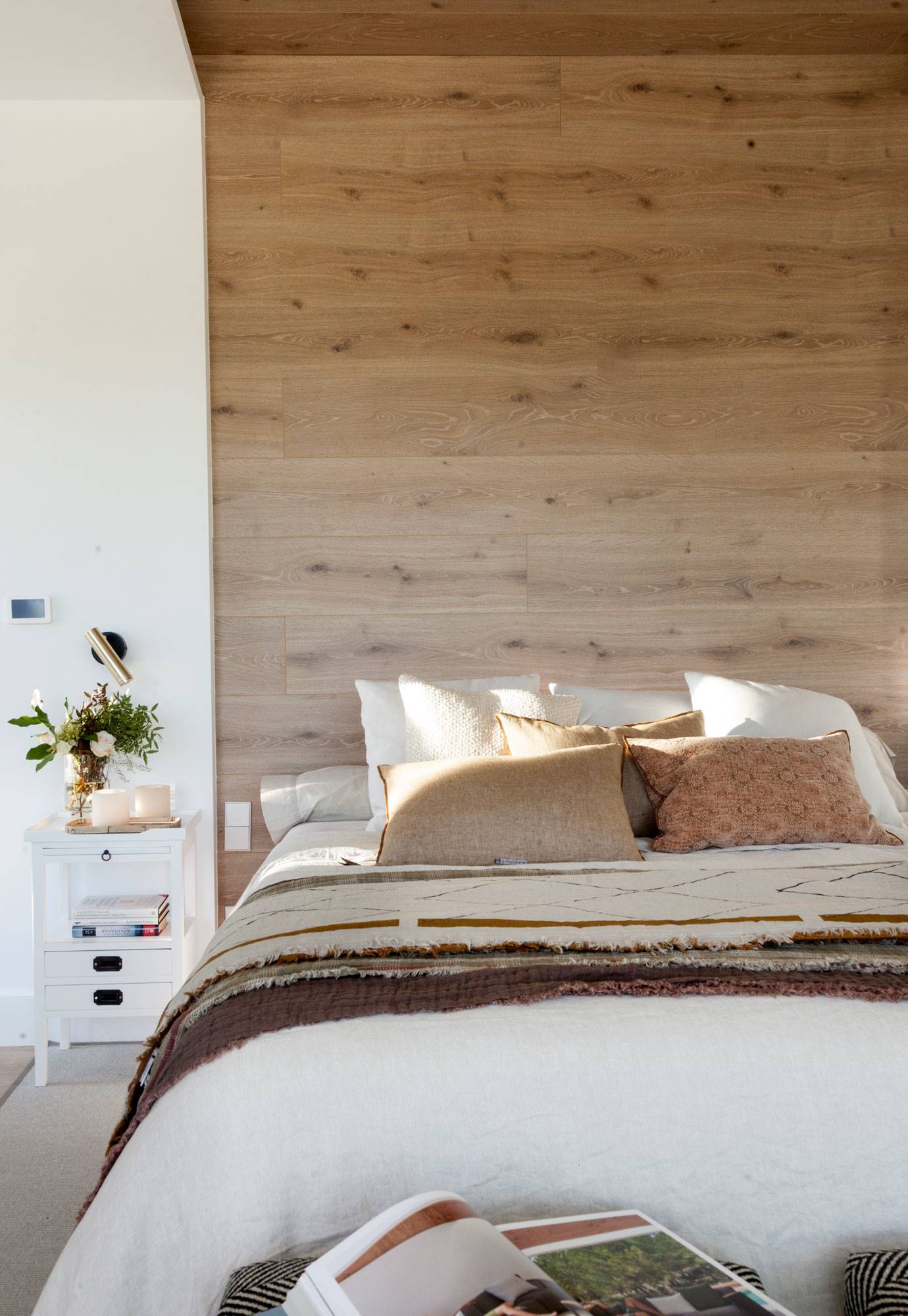 Dormitorio con pared del cabecero revestida con gres porcelánico.