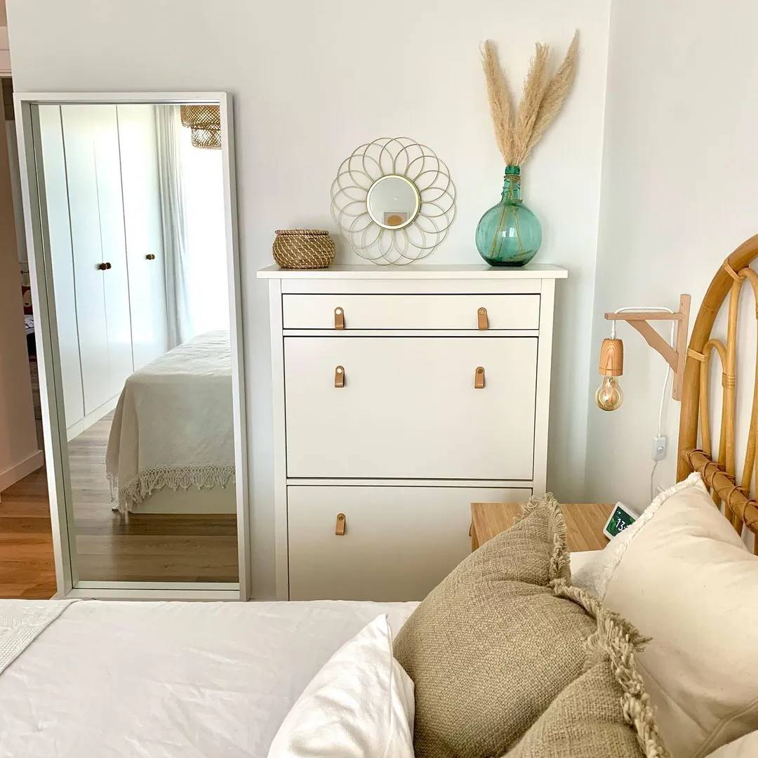 Dormitorio con zapatero blanco y espejo de cuerpo con marco blanco de IKEA.