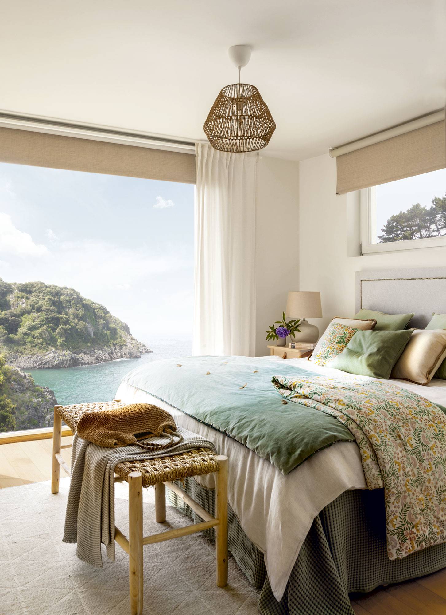 Dormitorio con grandes ventanas con vistas al mar. 