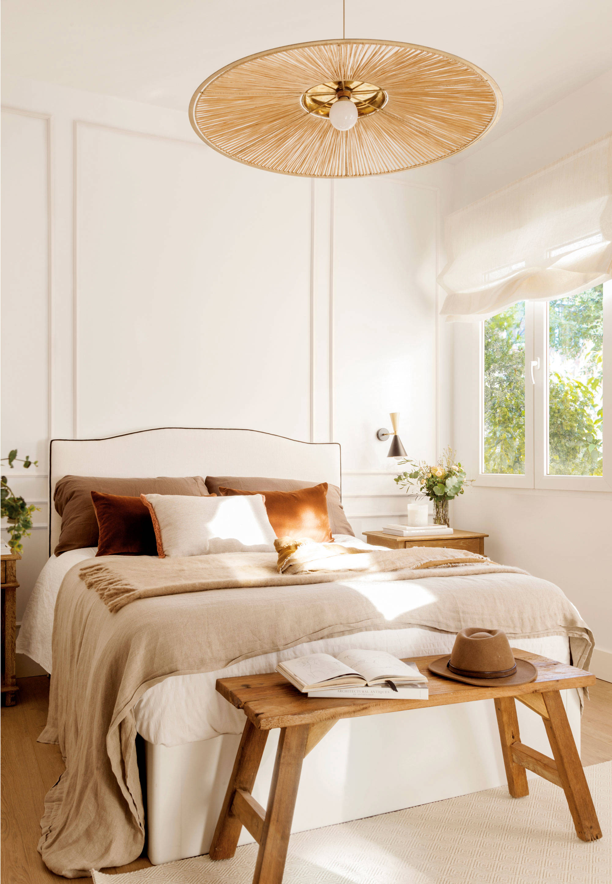 Dormitorio decorado en blanco y madera con lámpara de fibras. 
