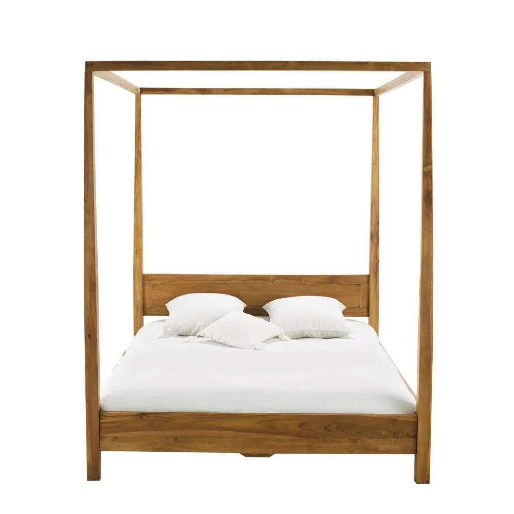 Una cama con dosel de madera