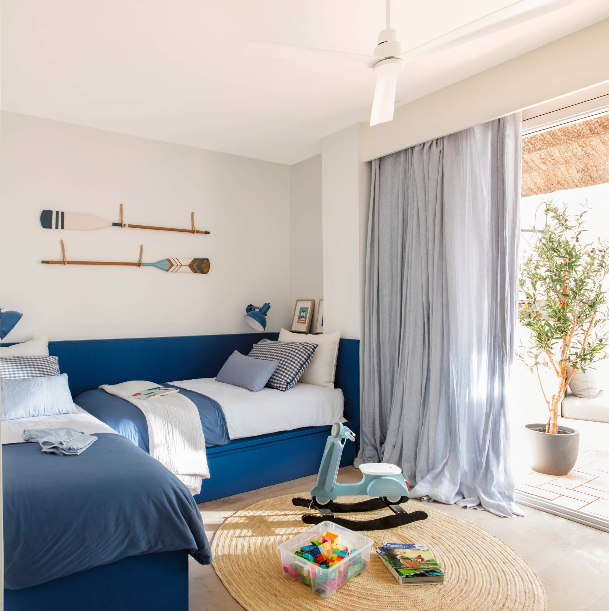 Dormitorio con camas azules y cajones